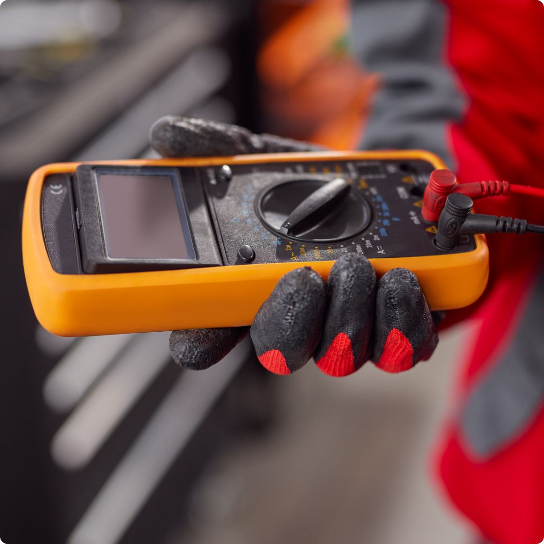 Worker with multimeter in his hand