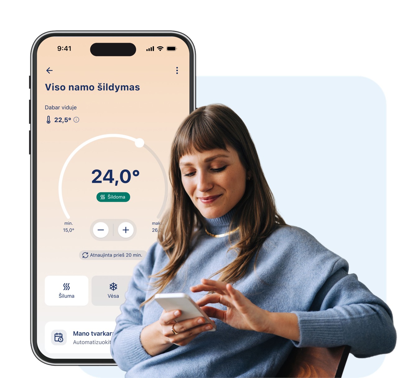 Moteris telefonu valdo viso namo šildymą programėlėje